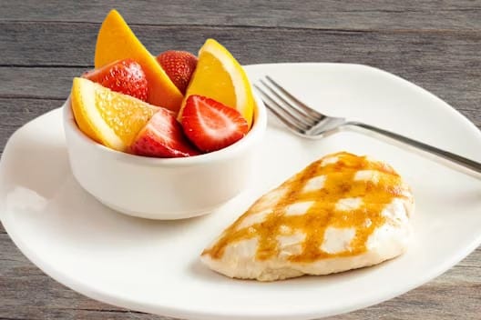 "Outback Steakhouse Grilled Chicken on the Barbie seasoned and flame-grilled, served with BBQ sauce and vegetables"