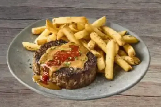 "Outback Steakhouse Spicy Jammin' Meatloaf glazed with sweet and spicy chili sauce, served with mashed potatoes and veggies"